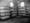 Still from black and white film featuring racks of cages filled with chickens in a battery farm.