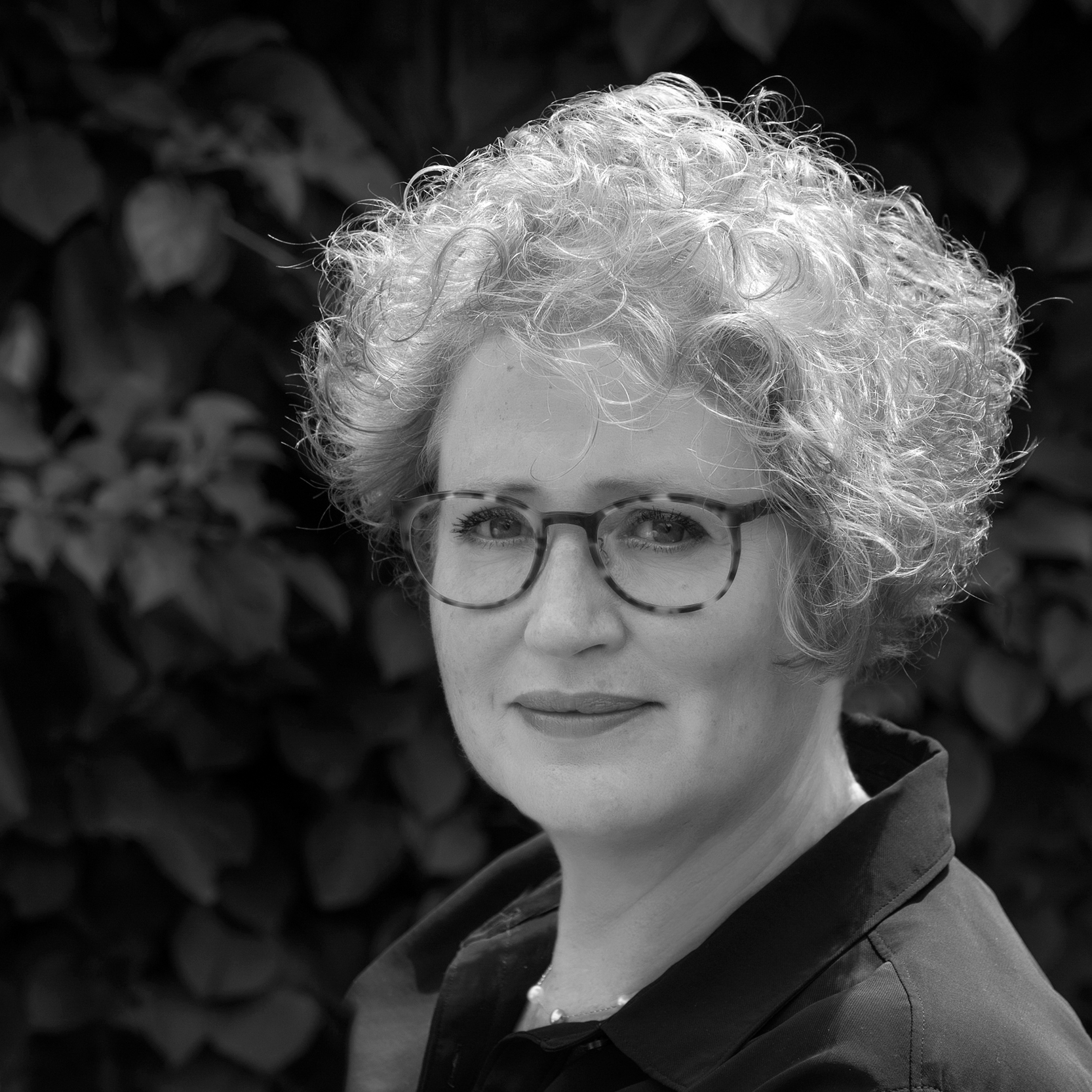 Black and white head and shoulders portrait of Stephanie Wynne.