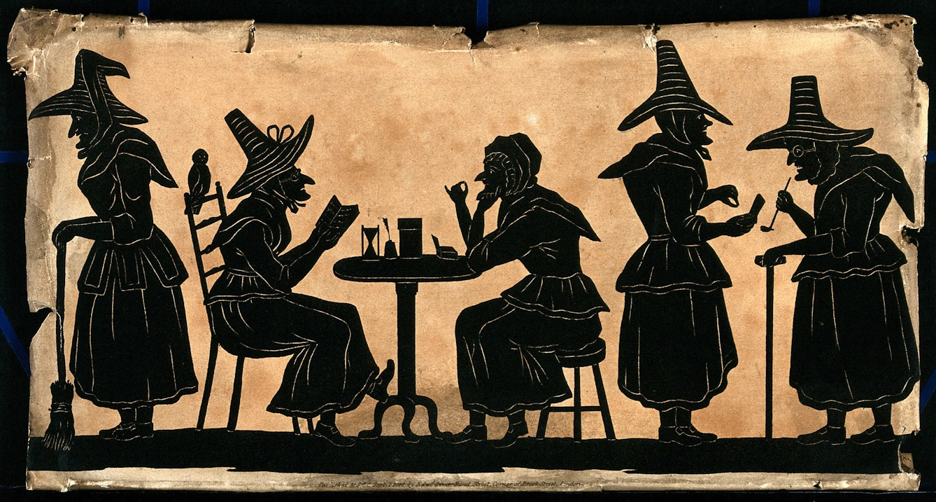 A black and white image showing the silhouettes of five people. Three standing and two are sitting at a small table. Four are wearing large, tall hats with wide rims. 