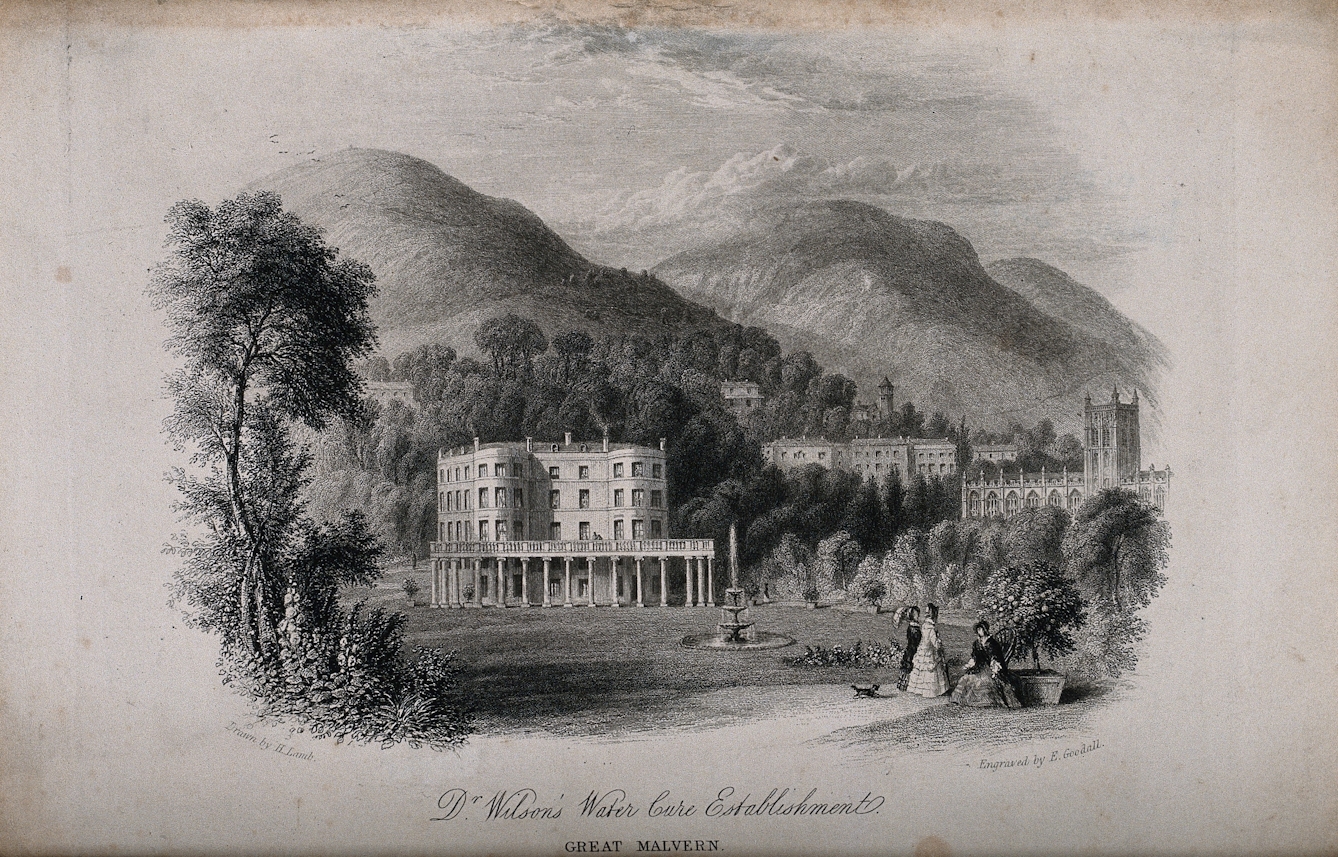 Black and white etching showing people in long-skirted outfits walking in the grounds beside a large white building with trees and hilly countryside behind.