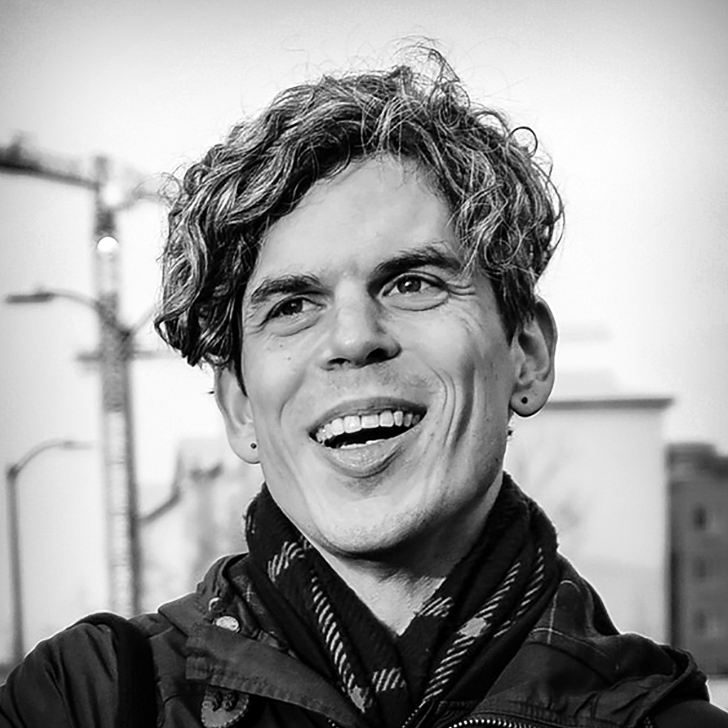 Photographic, black and white, head and shoulders portrait of Aaron Asis.