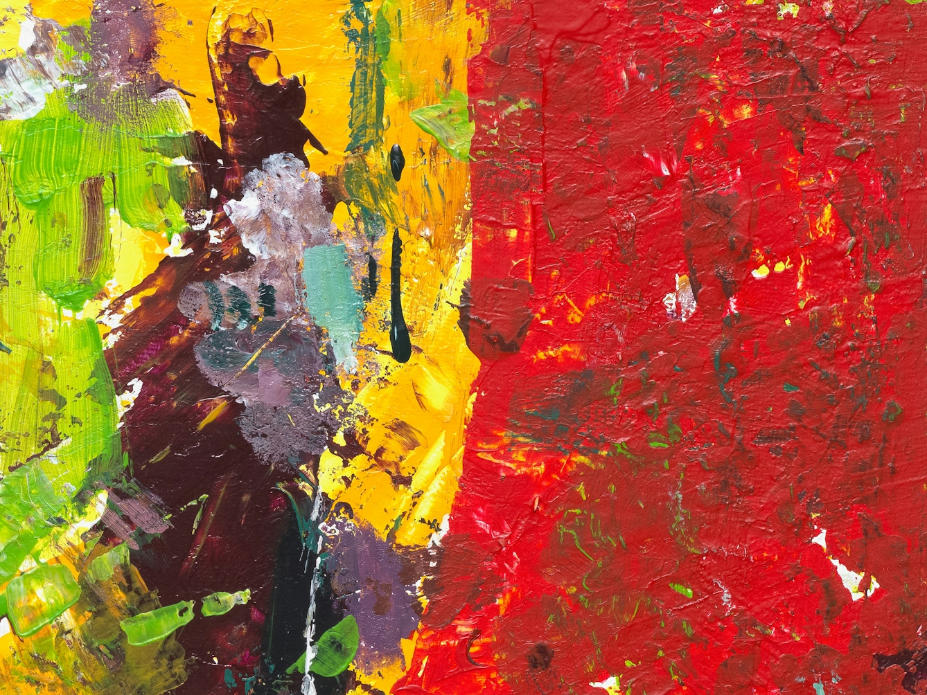 Photograph of close-up detail of a larger abstract expressionist painting utilising acrylic paint on a rectangular canvas in landscape orientation, titled 'Boundaries'. The artwork explores themes of setting clear boundaries, giving consideration to our privacy, and potential oversharing.
A vast majority of the canvas surface contains harmonious marks and gestures of earthy tones - including yellow, green, teal, burgundy, brown, orange and white. It's akin to a dense, blooming meadow of various plants and flowers. To the right-side, an overlapping band of red sweeps across the focal layer and creates a very distinct barrier and contrast, in both colour and textural quality.