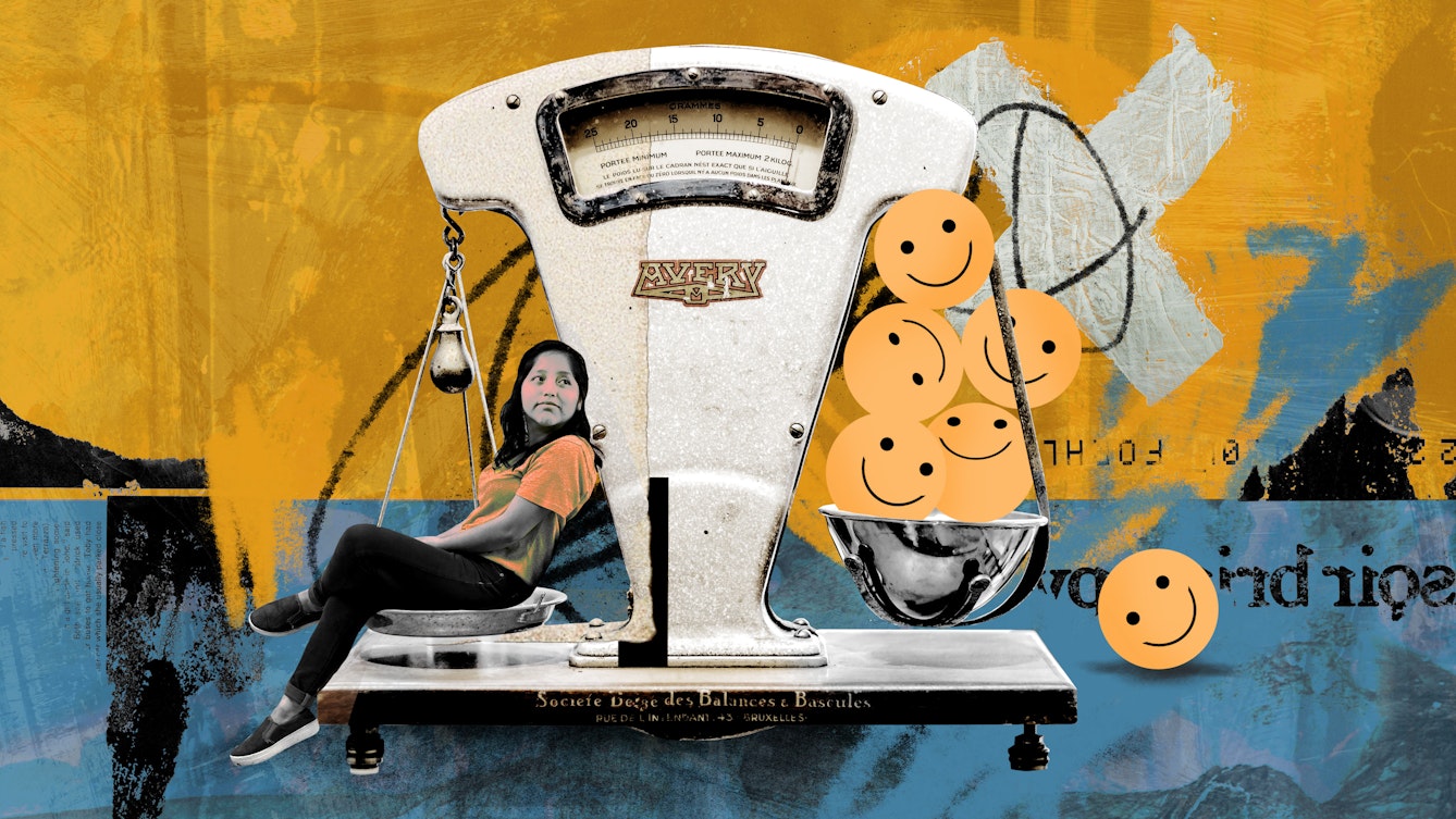Colourful collage artwork with various elements.

The central element is a two-sided balance scale. In one of the measuring cups there is an image of a young woman sitting, she is wearing an orange t-shirt and black jeans. In the other cup are some smiley faces, one of them has fallen towards the ground. This side of the scale is higher than the side with the woman in it. 

Behind the scales, the top half of the background is yellow and has a white cross sign painted on it. The bottom half is blue, with some text written on it. 