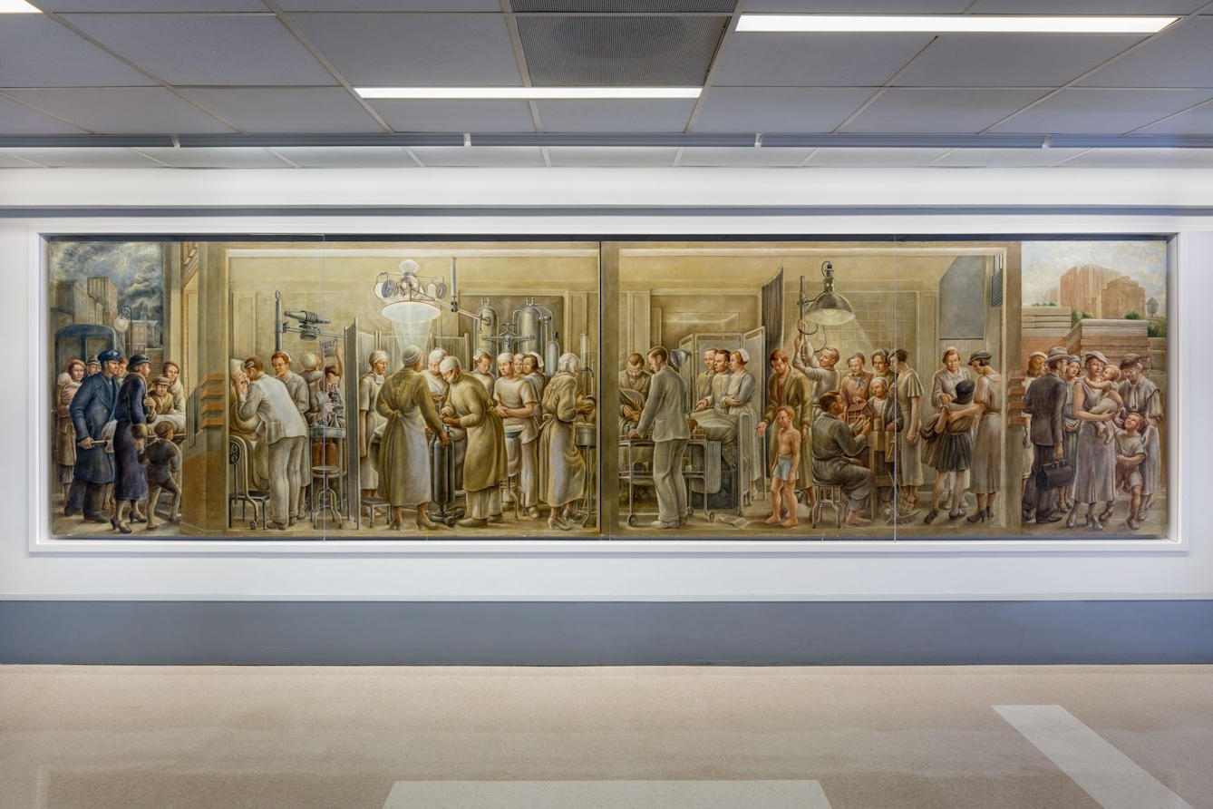 Colour photograph of a large landscape painting on display in a contemporary hospital setting.