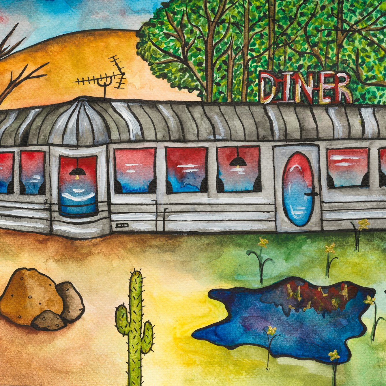 Colourful artwork. The artwork shows a grey building with a sign reading 'Diner' attached to the roof. There is also an aerial on the building roof. On the right side of the scene there is a woodland and the grass is green with flowers growing and a small pond. Immediately to the left of this, the ground is brown with rocks, cacti and trees with bare branches. Above these are several hills.