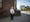 Photographic full length portrait of Dr Shiv Pande, a retires general practitioner, outside his former surgery in Liverpool.