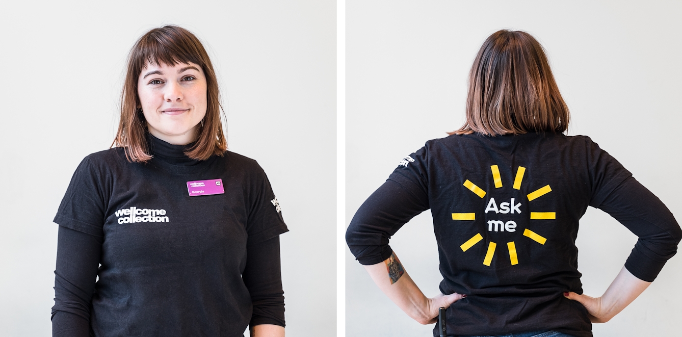 Diptych. The photograph to the left shows a smiley Visitor Experience Assistant wearing a black t'shirt with a white Wellcome Collection logo and a pink name badge. The photograph to the right features the same Visitor Experience Assistant seen from the back. On the reverse of the t-shirt it says 'Ask me' in large white letters with straight yellow lines radiating outwards in a circle like a child's drawing of a sun.