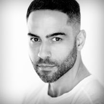 Photographic, black and white, head and shoulders portrait of Christopher Andreou.