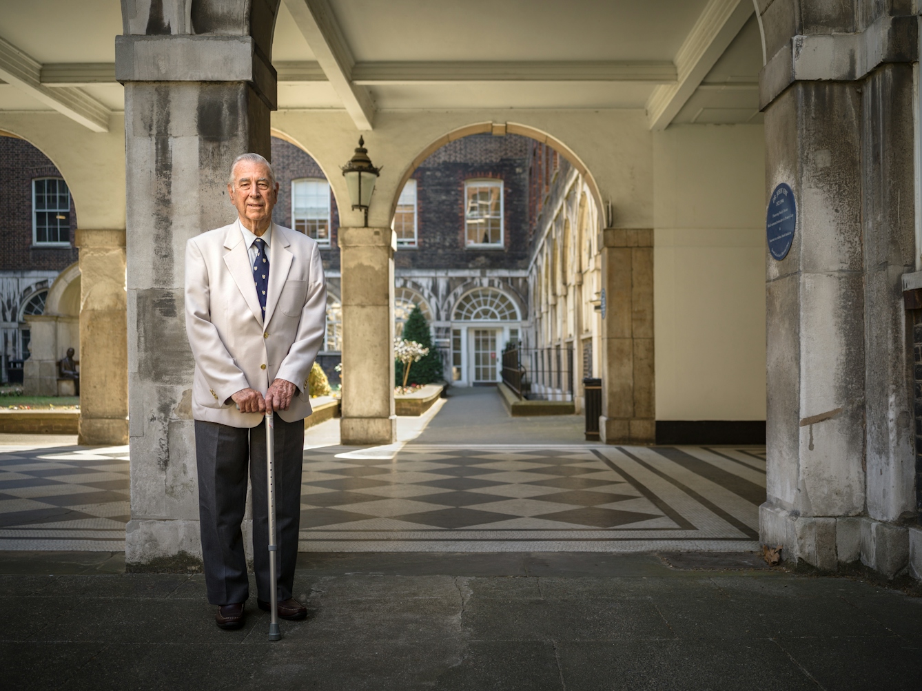 Photographic full length portrait of Leslie Cheeseman, a retired dentist, at Guy's Hospital.