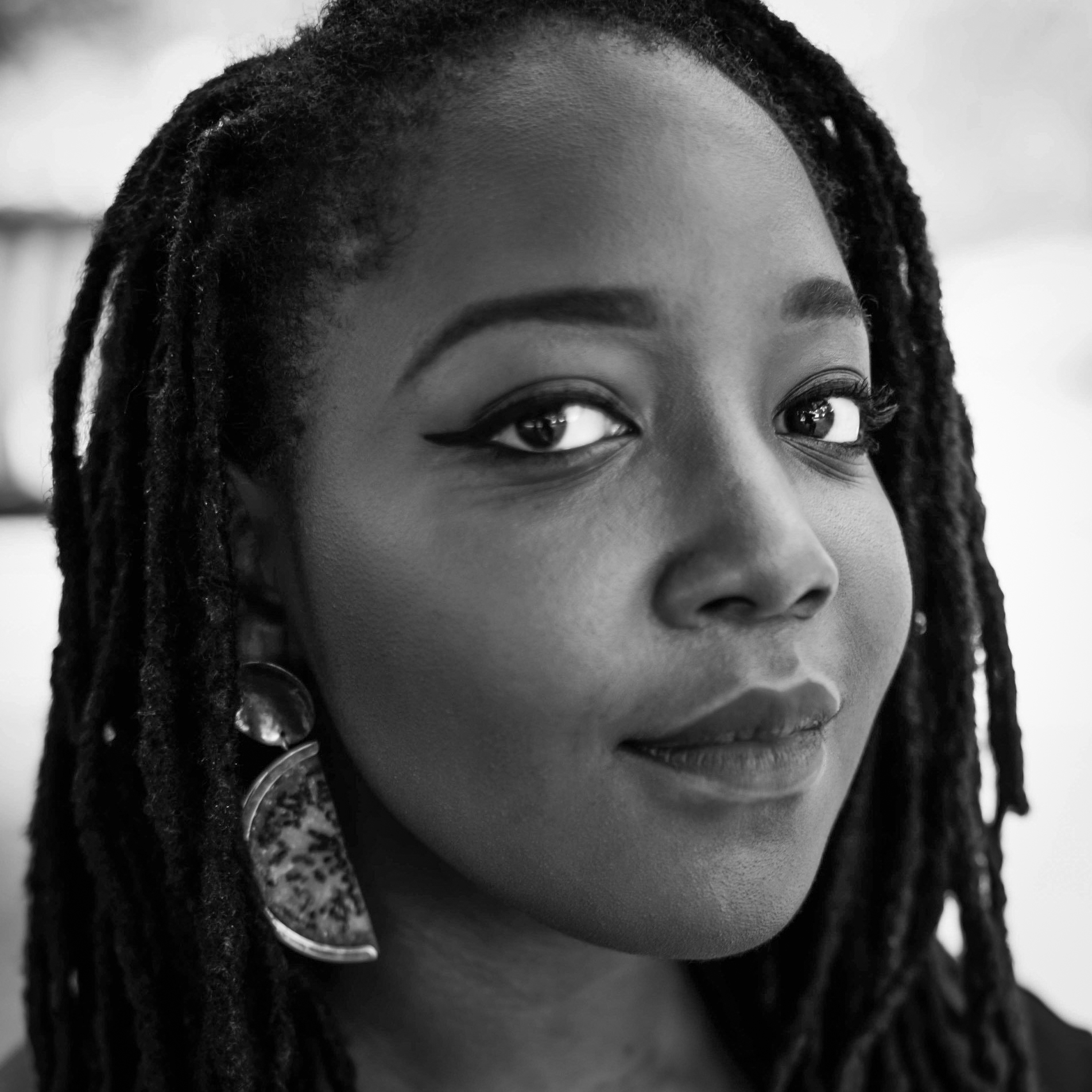 Black and white, head and shoulders portrait of Naki Narh.