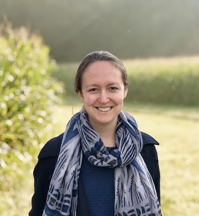 A headshot of Anne Wallentine, smiling and wearing a scarf
