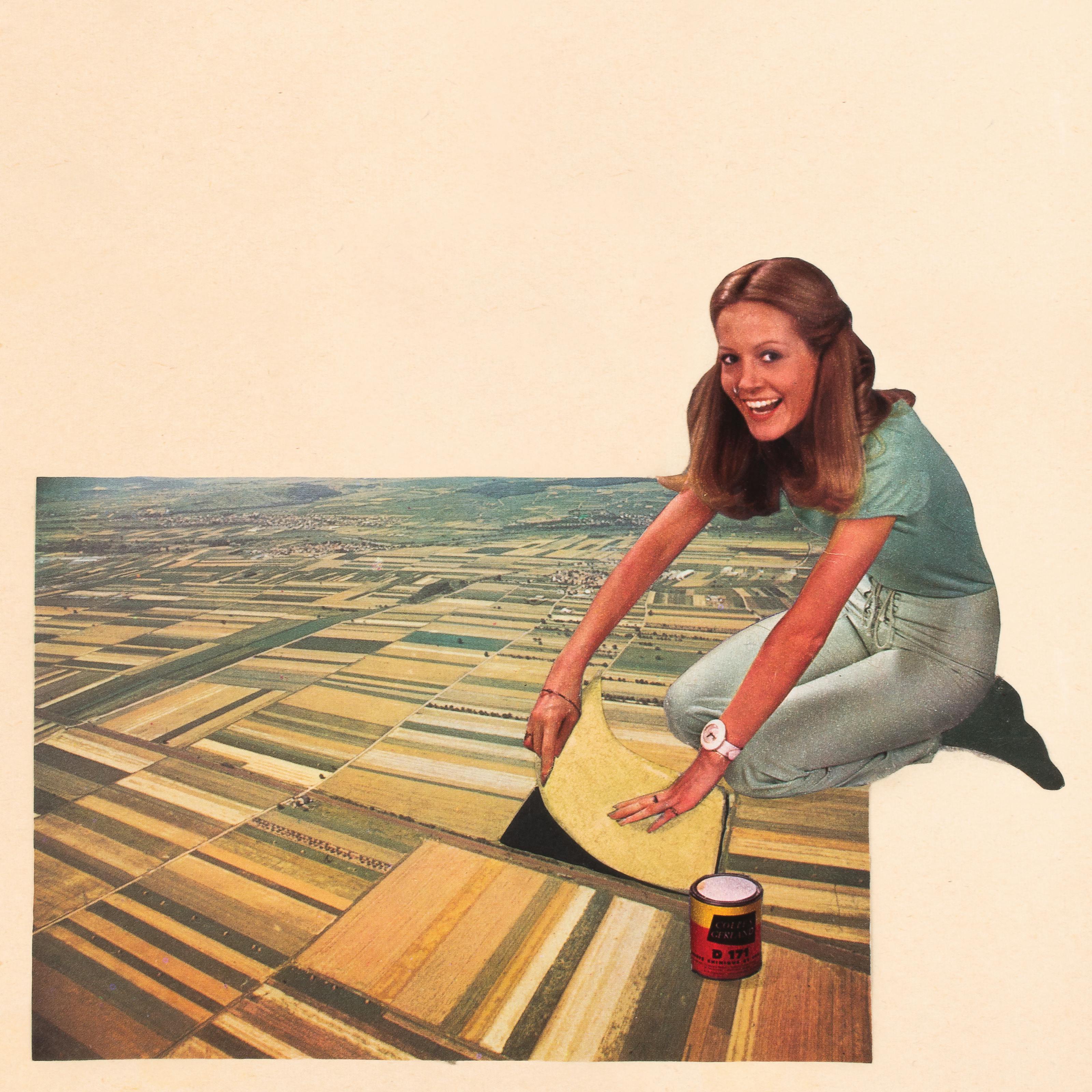Paper collage artwork of a gigantic woman kneeling on an agricultural landscape. The woman appears to be peeling away one of the farmers fields showing an expression that reads both as joy and mischief.