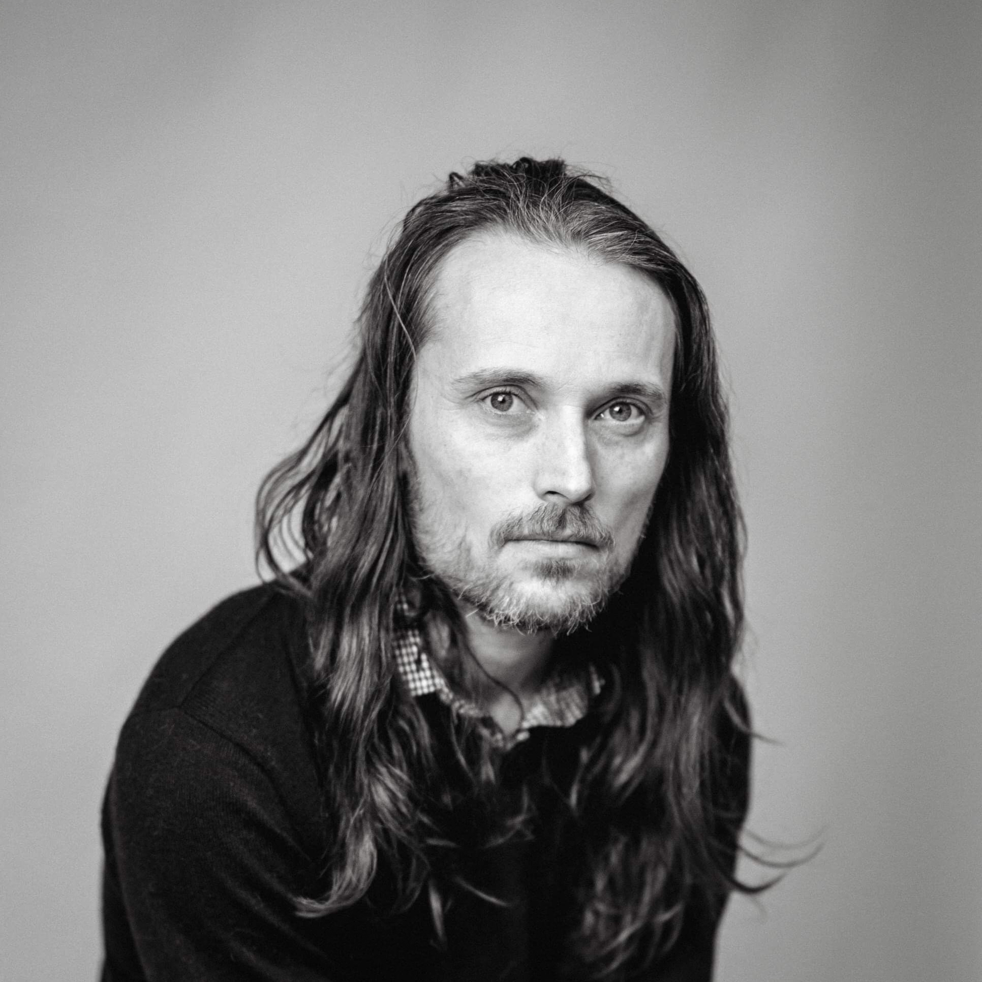 Black and white head and shoulders portrait of Ian Treherne.