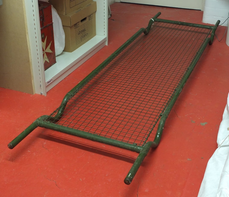 Photo of metal stretcher against red floor