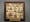 Image of embroidered square with wooden frame.