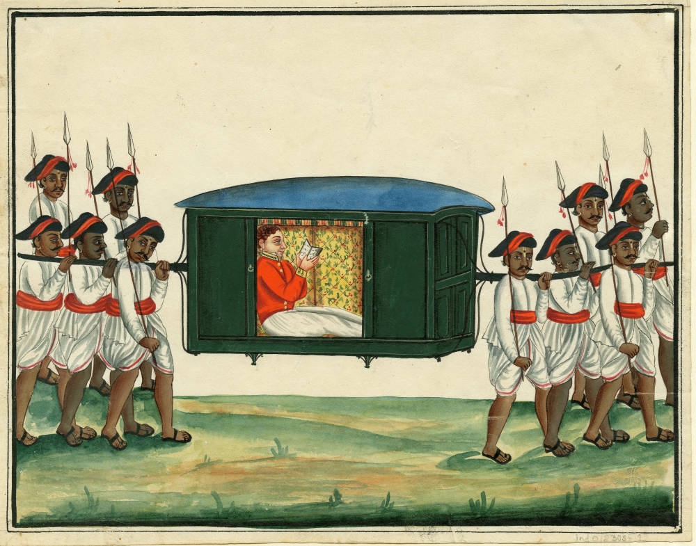An English army officer in a red jacket reading in a palanquin carried by six Indian men and accompanied by another four Indian men in uniform carrying spears