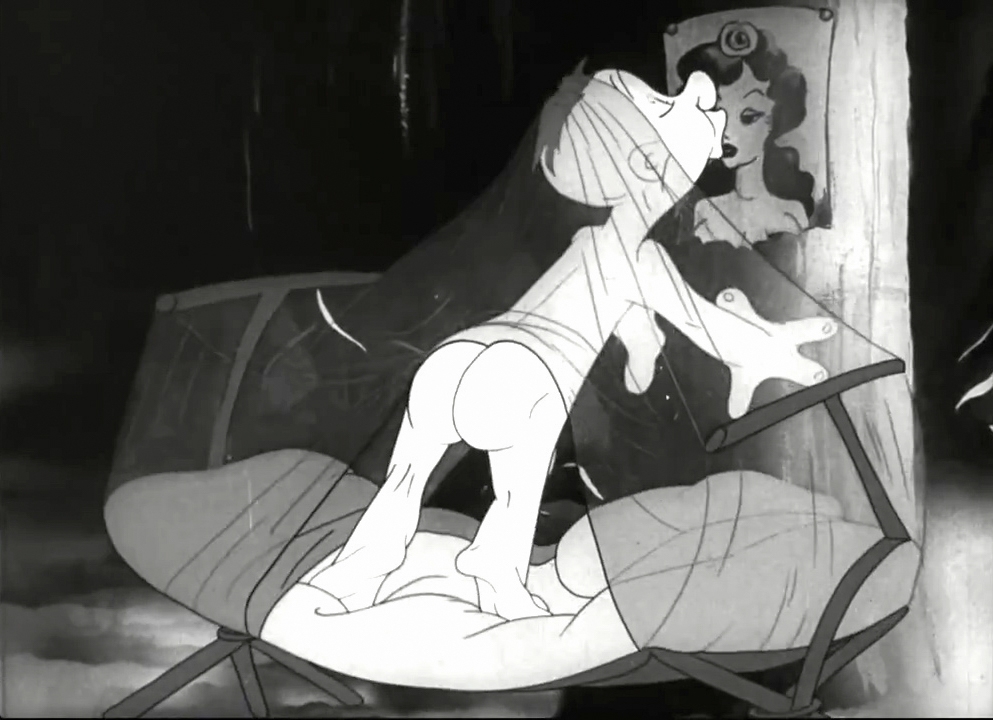 Black and white still image from the film 'Private SNAFU vs. Malaria Mike'.  SNAFU is standing up in bed to kiss the picture of his girlfriend, thereby exposing his bare behind for Malaria Mike to sting him.