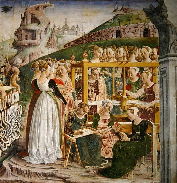 15th century painting of a small group of women working on needlework projects. Behind them are a larger group of well-dressed women waiting. In the background of the painting are several castles and buildings. 