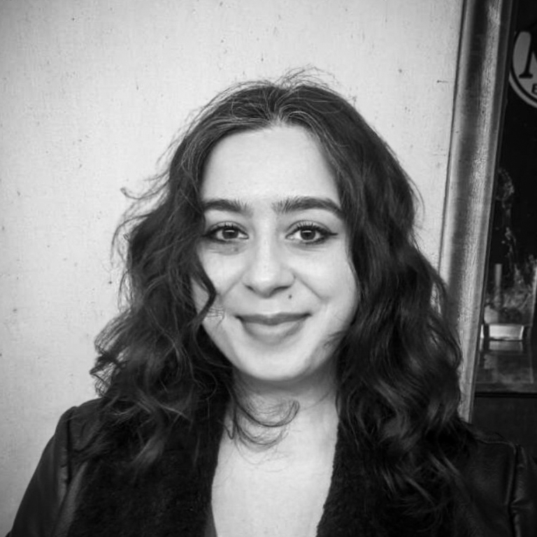 Black and white head and shoulders photographic portrait of Asma Istwani.