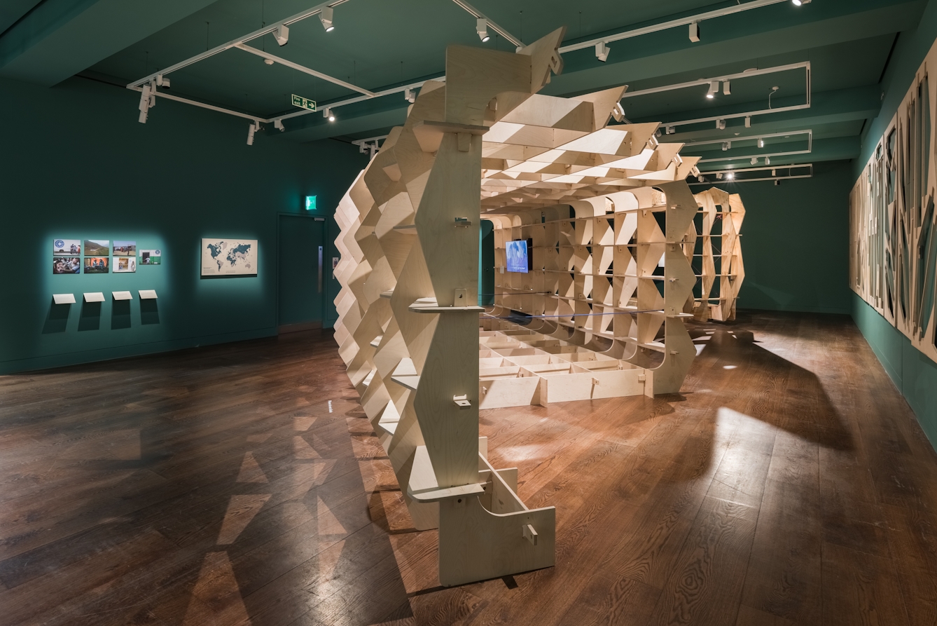 Photograph of the Global Clinic prototype, a wooden structure built in the gallery space at Wellcome Collection.