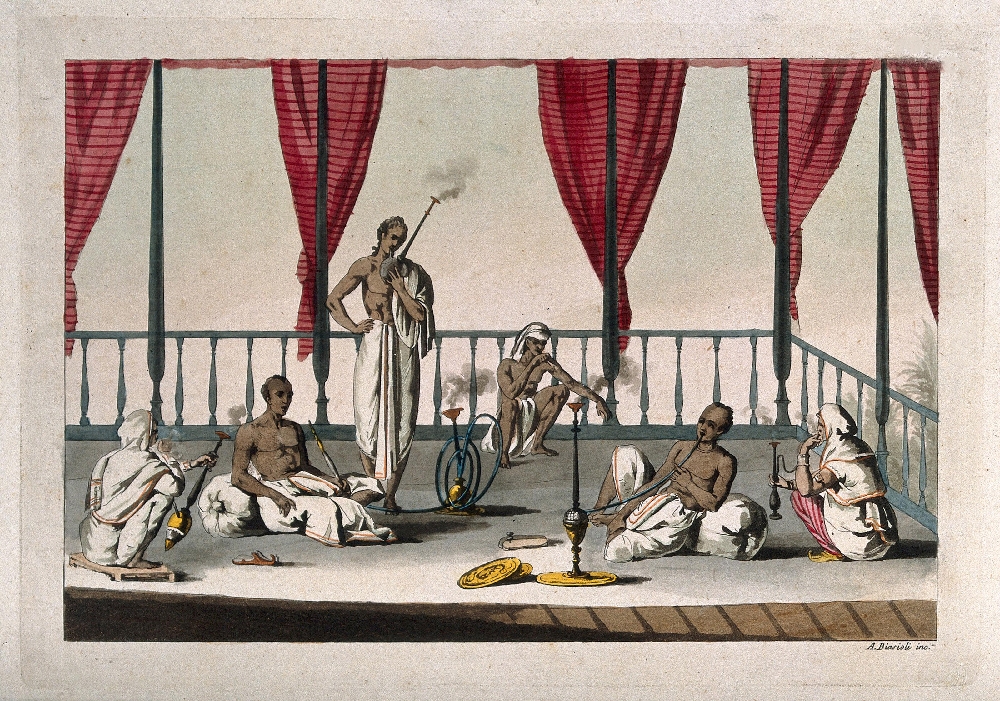Six standing and sitting Indian men smoking a variety of types of hookah on a verandah