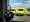 Photographic portrait of Mandy English, paramedic, at Hull East Ambulance Station, with ambulances in the background.
