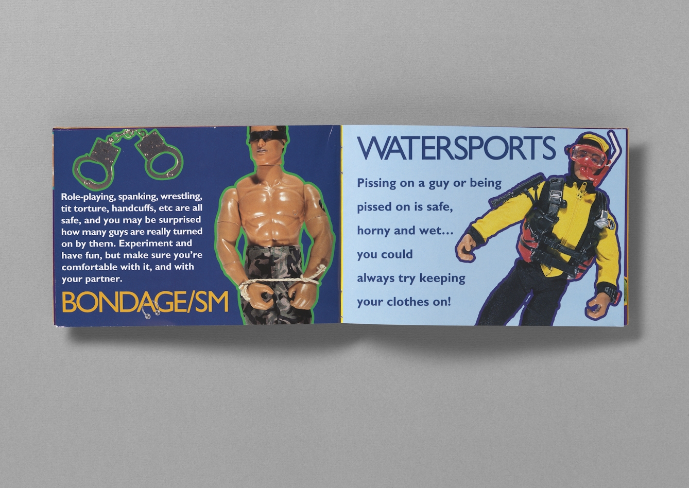 Colour photograph of the inside of a booklet called "Get ready for Action: a gay man's guide to safer sex". The pages photographed show Action Man toys, one with a blindfold and rope around wrists, to represent bondage, and another in snorkeling gear, to represent sexual watersports. 