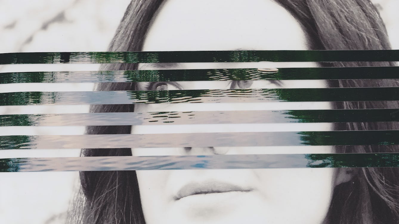Mixed media collage artwork using a combination of two different photographic prints. The background of the collage is made up of a black and white photograph of the head of a young woman with long dark hair. She is looking off to camera left with a neutral expression on her face. Overlaid on top of her portrait, running through the centre of the image, are horizontal strips of a colour photograph showing a large expanse of open water with the ripples on the surface of the water visible through the light and dark reflections. The horizontal strips are spaced out such that the portrait beneath can be seen through the gaps.