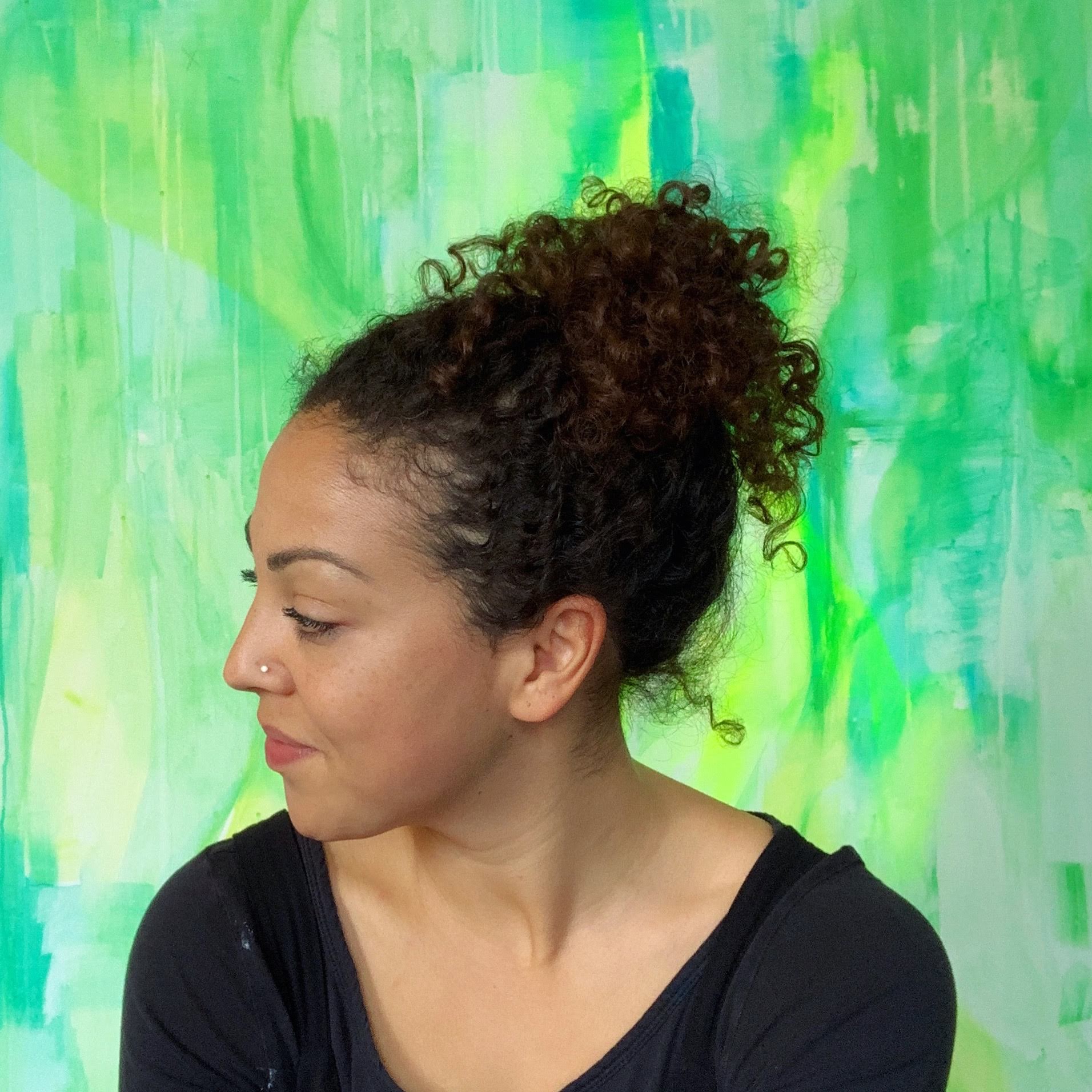 Head and shoulders photograph of a woman looking to her right and slightly downwards