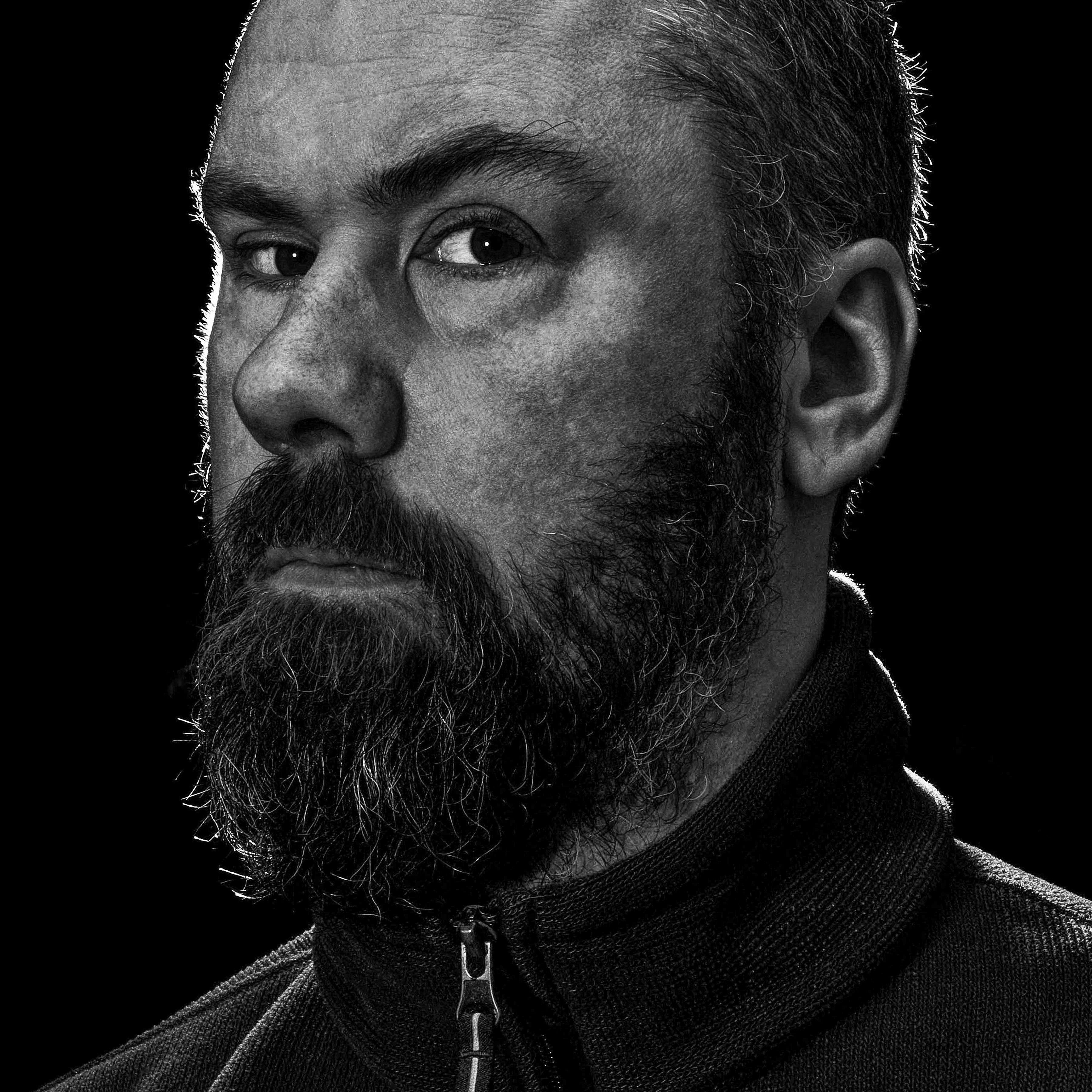 Black and white head and shoulders photograph of Colin Potsig.