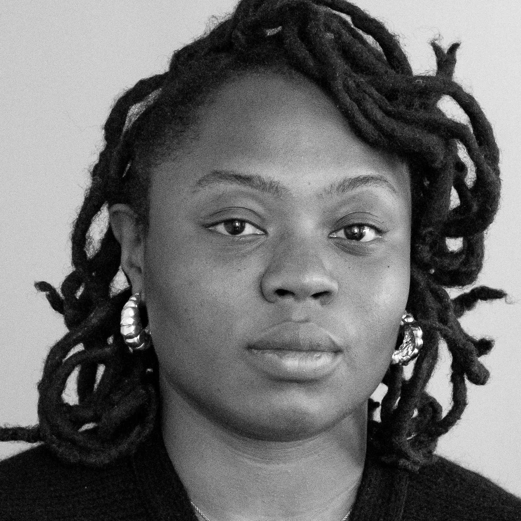 Black and white, head and shoulders photographic portrait of Yvonne Maxwell.