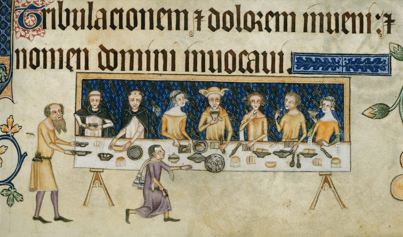 An illustrated manuscript showing nine figures gathered around a dining table laden with food and dishes.