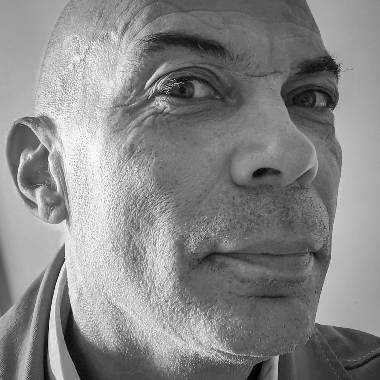 Black and white, head and shoulders photographic portrait of Chris Arran.