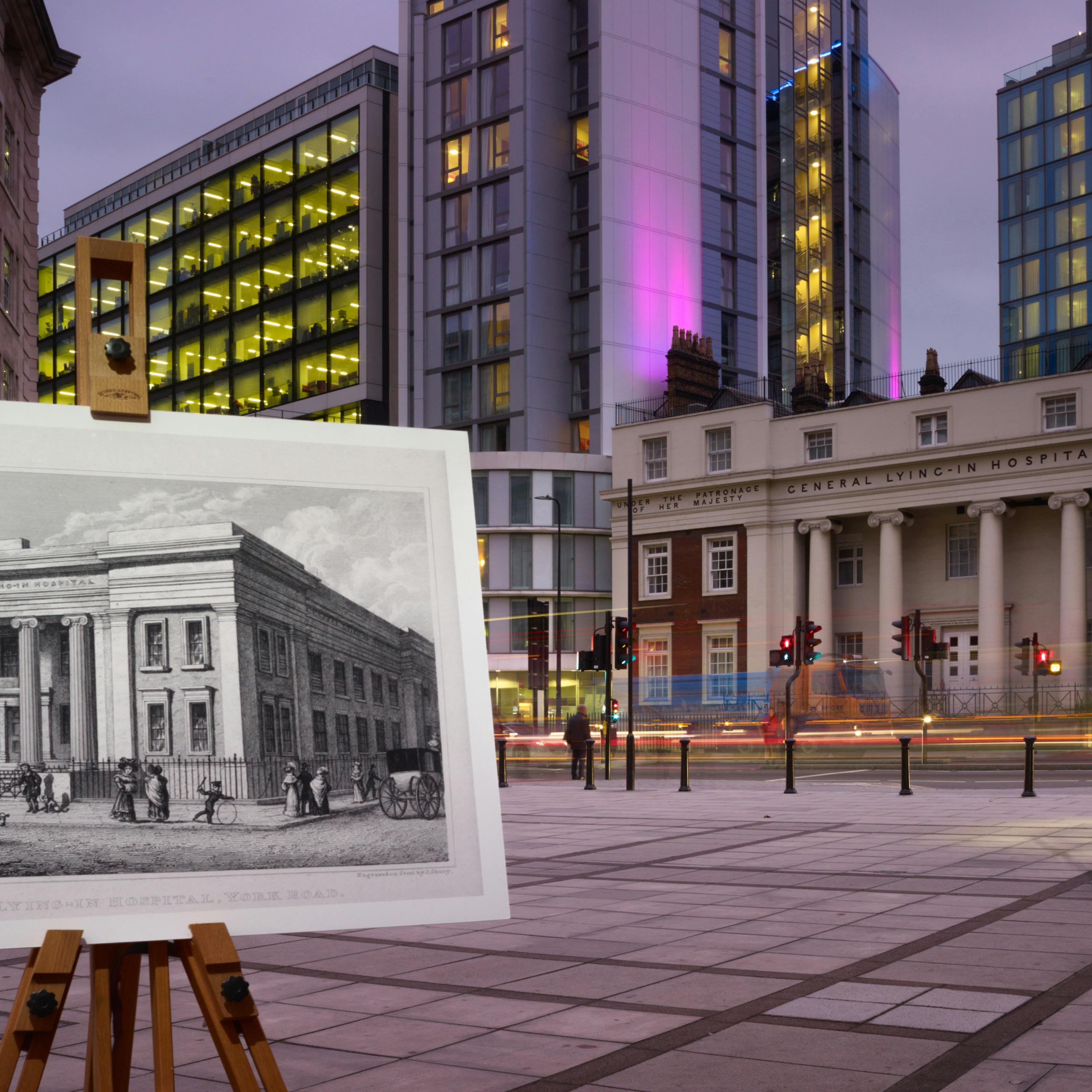 Photograph of the former General Lying-In Hospital with an historical image of the hospital displayed in front of it on a wooden artist's easel.