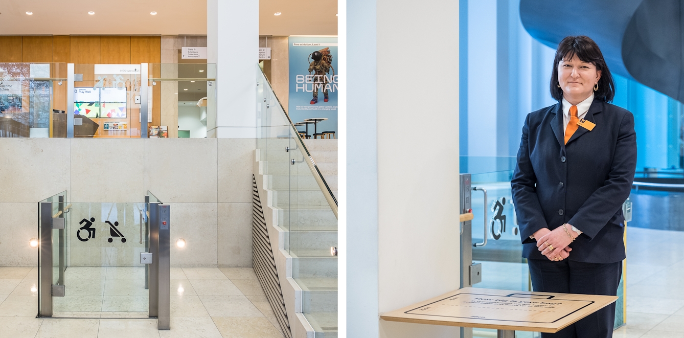 A diptych. The photograph to the left shows the inside of the entrance to the Wellcome Collection with an open air lift with a glass push-button door for wheelchair and pushchair access.  Alongside this is a short staircase, both of which take you up to the atrium visible above where further lifts, a spiral staircase, a cafe, and a bookshop are located. The photograph on the right shows a member of security staff standing behind a small table for bag checks to take place.
