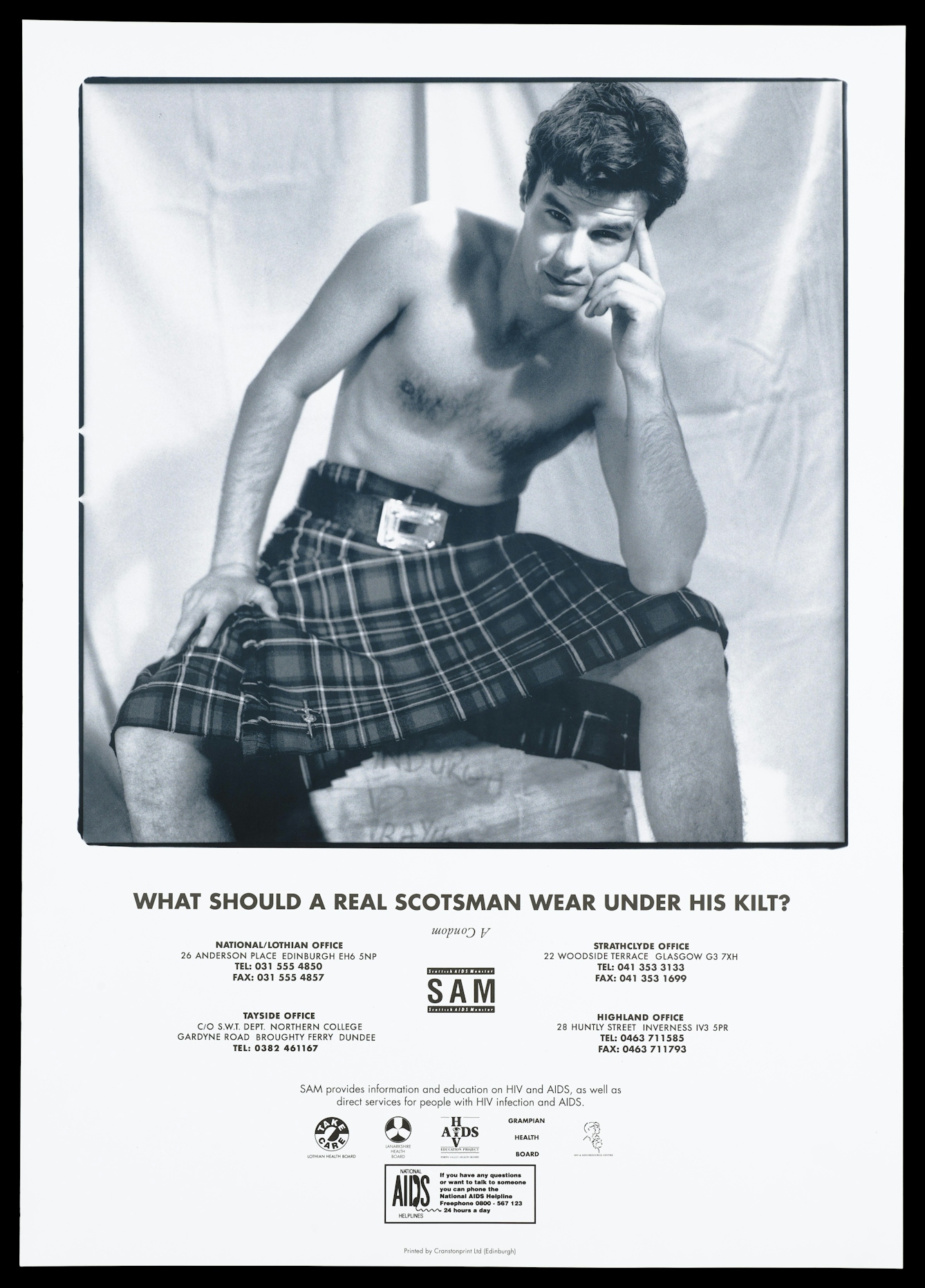 Black and white lithograph featuring a seated bare-chested man wearing a belted kilt. His left elbow rests on his knee, with his hand on his face in a pose reminscent of The Thinker by Rodin. He is smiling and his eyebrows are raised provocatively. The text under the image asks "What does a Scotsman wear under his kilt?" and provides telephone numbers for AIDS organisations and the Scottish Aids Monitor logo. 