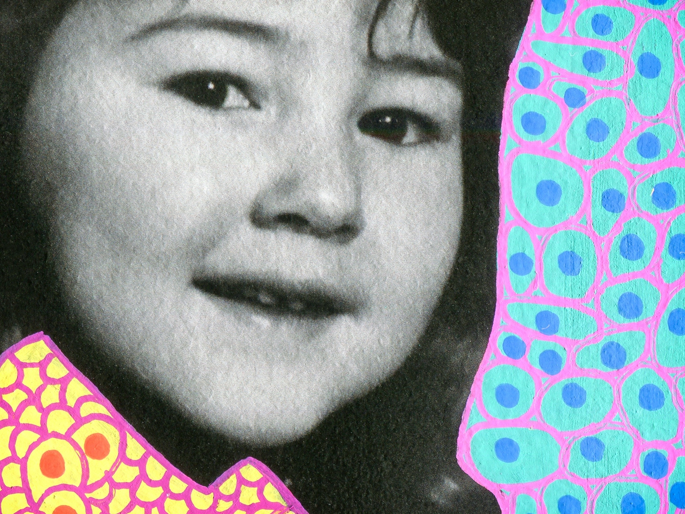 Artwork created by painting over the surface of a black and white photographic print with colourful paint. The artwork shows the original head of a young girl from the photograph beneath. The girl's face almost fills the image and she is smiling to the camera. Apart from her head and face, the rest of the image is a painted cyan background covered in small blue dots and purple lines forming cell like structures around the blue dots. The girl's clothes are painted differently, with a yellow background, covered in orange dots, surrounded by loops of purple lines, arranged almost like scales or feathers. The texture of the paint can be seen.