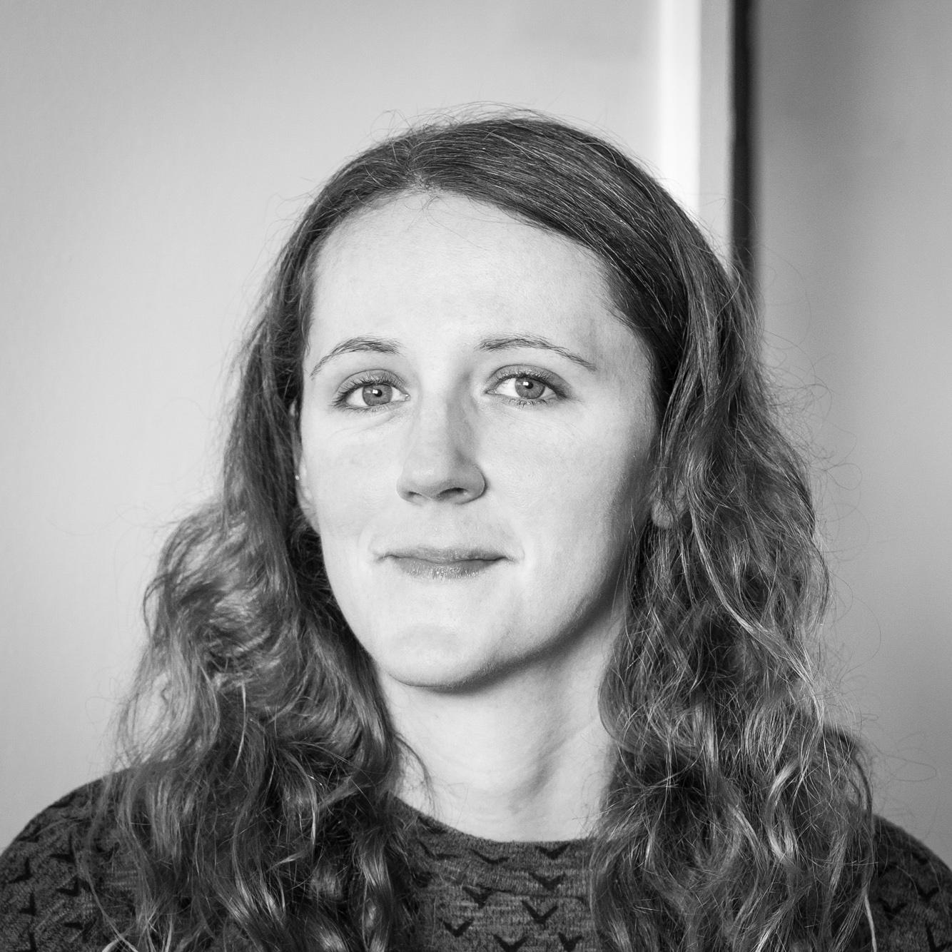 Black and white head and shoulders portrait of Jasmine Owens.