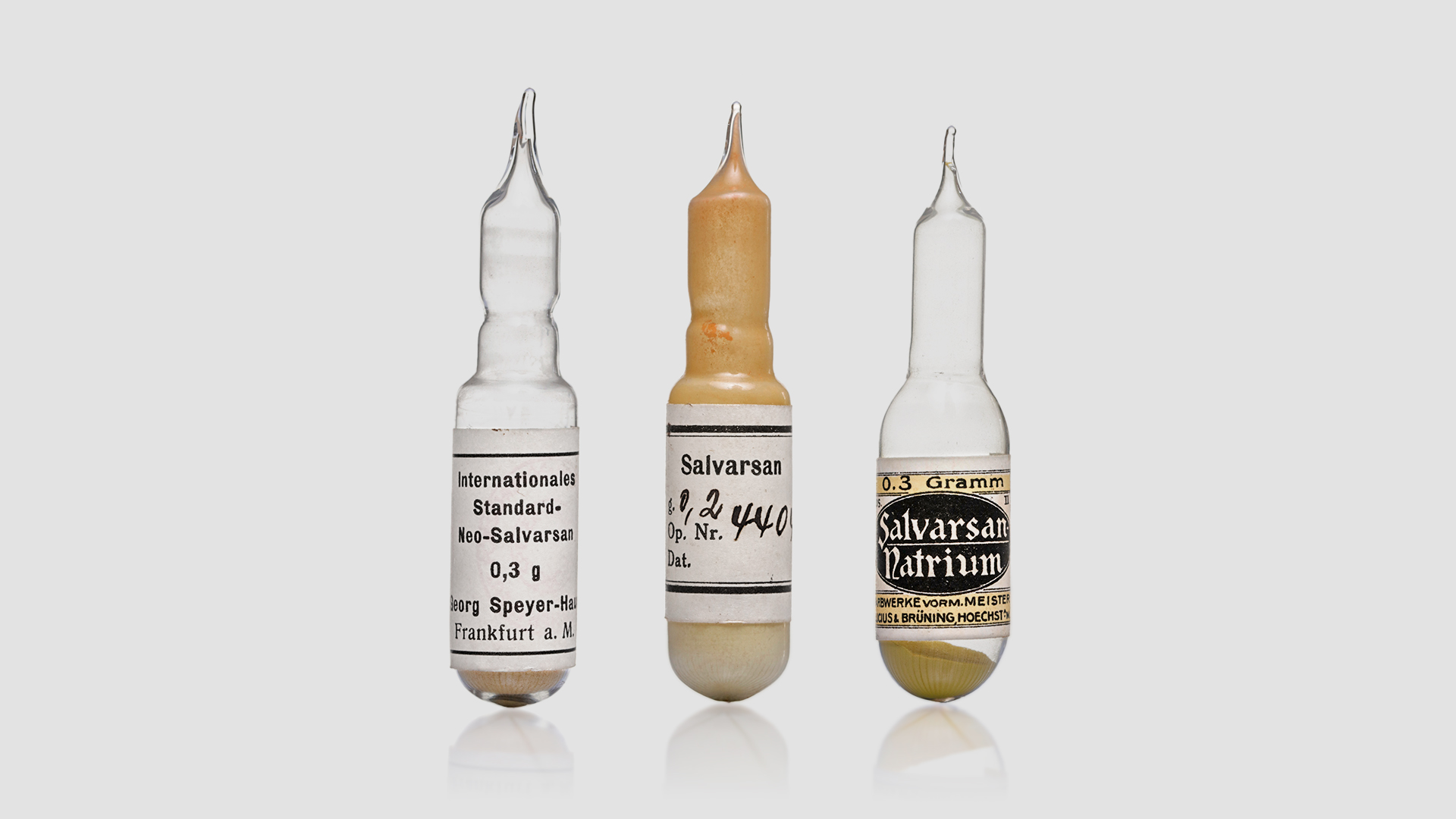 Three glass ampoules containing arsenic compounds, including Salvarsan and Neo-Salvarsan. 