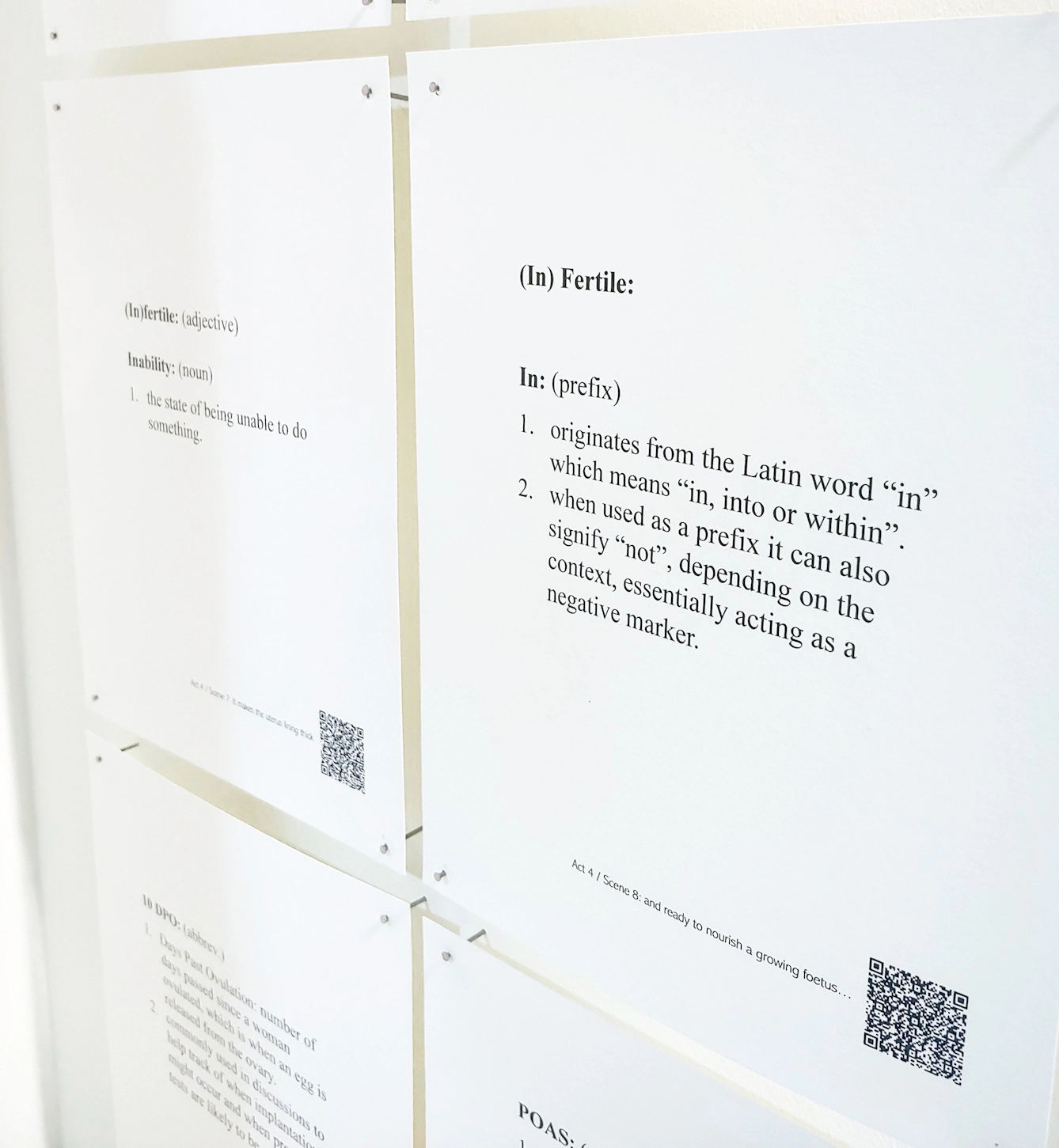 Detail of printed pages of text mounted on a wall. They include a medical devinition of infertility. The text reads:

"(In)Fertile: In: (prefix)

1. originates from the Latin word "in" which means "in, into or within".

2. When used as a prefix it can also signify "not", depending on the context, essentially acting as a negative marker."