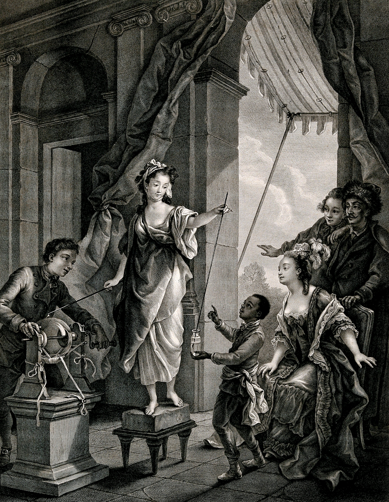In this demonstration the boy is about to touch the rod, which will discharge an electric shock. The audience watches expectantly.