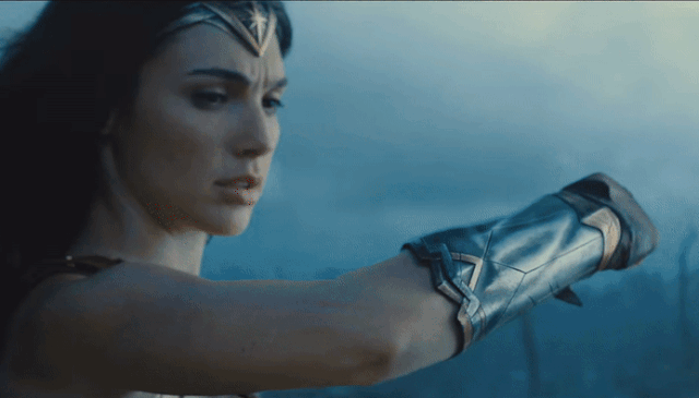 Wonder Woman shows her gauntlets.