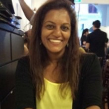 Head and shoulders photograph of a woman with long hair, smiling and looking to camera.