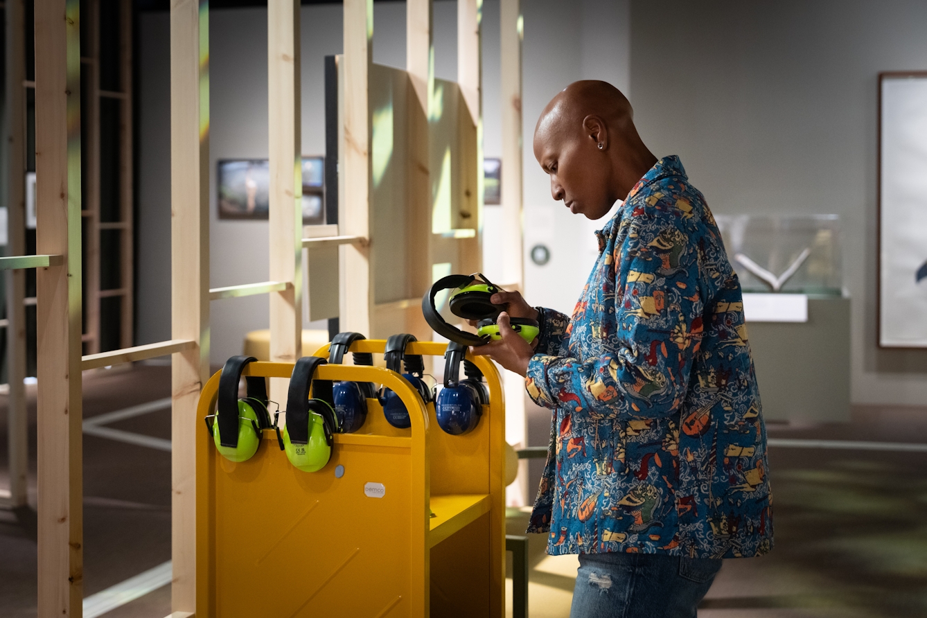 Photograph of a person looking at equipment available in the exhibition