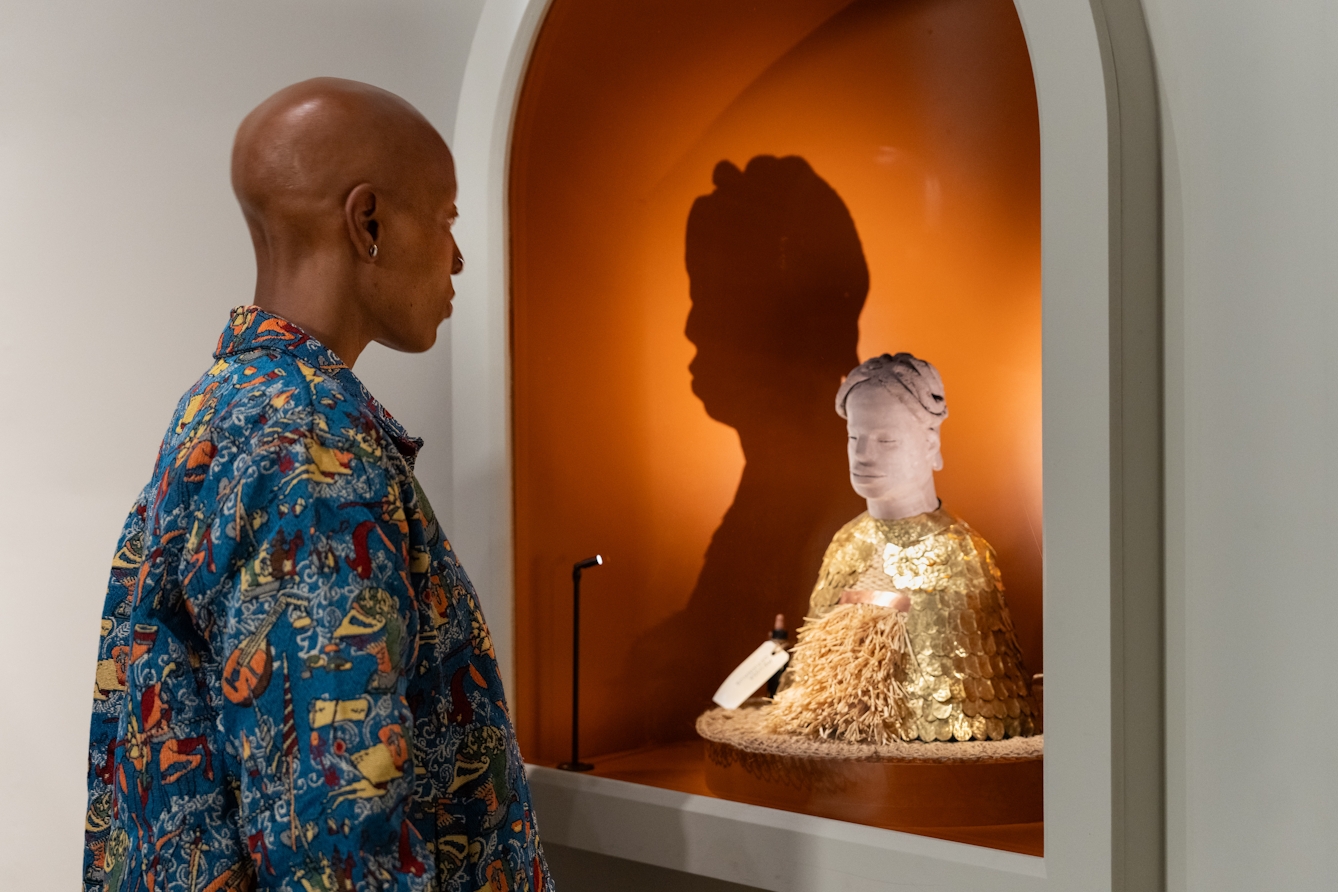 Photograph of a person looking at a sculpture in the exhibition