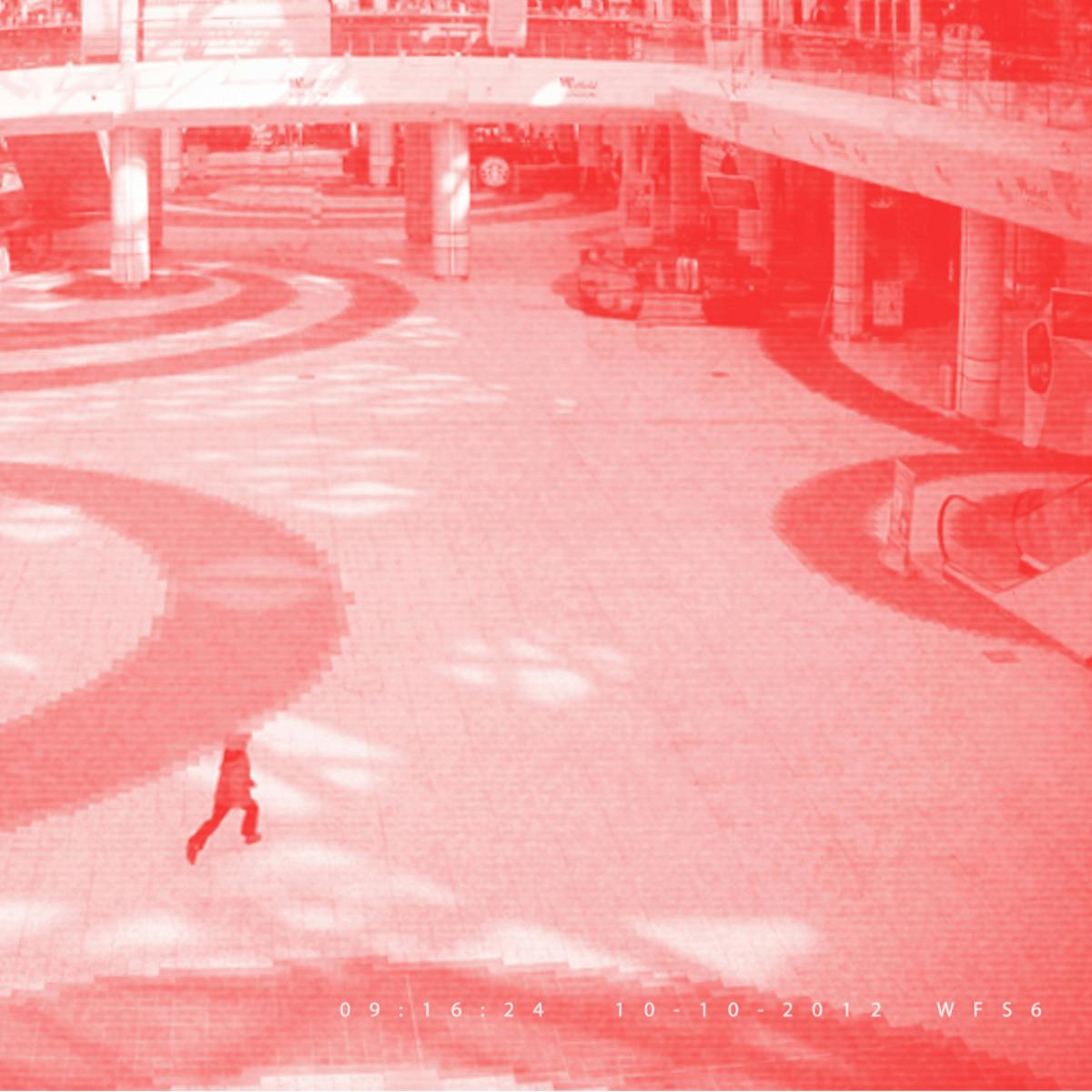 Pixellated photograph from a shopping mall security camera, where all adults have been crudely 'Photoshopped' out of the image, leaving one remaining child. The image has a red/pink tone applied to it.