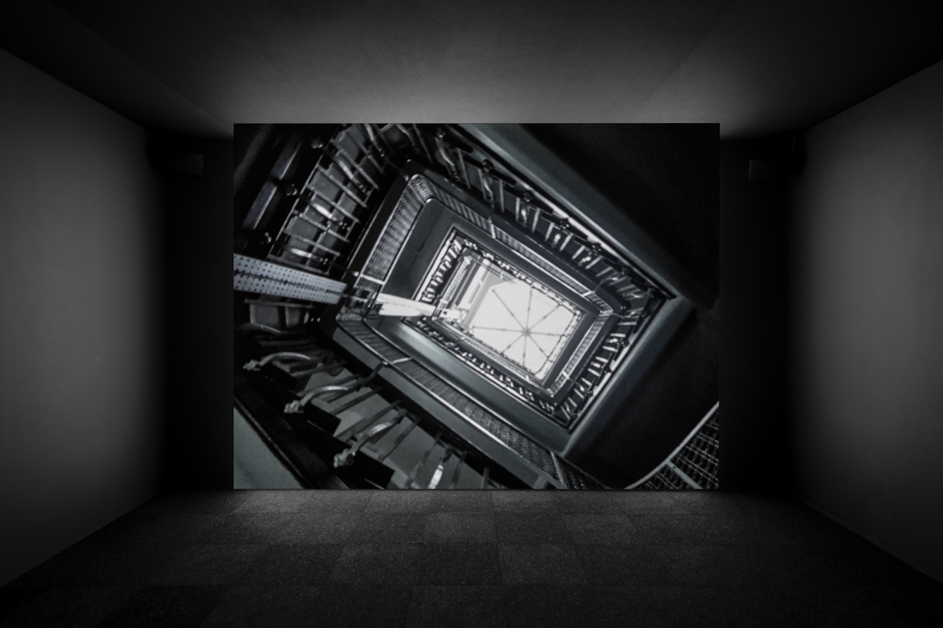 Photograph of a projector screen showing a film installation as part of the exhibition, Living with Buildings at Wellcome Collection 