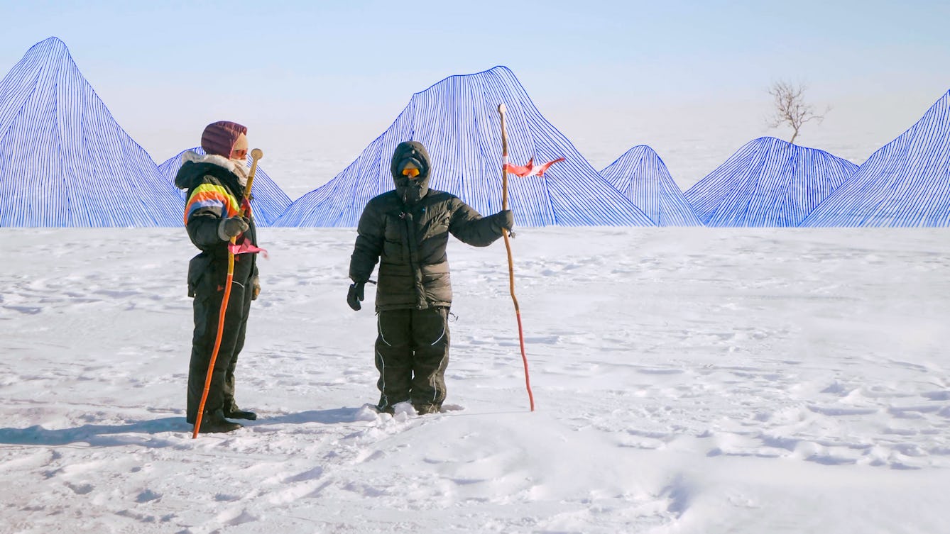 Photograph of artists, Outi Pieski and Jenni Laiti holding Sámi walking sticks at the top of a snow covered mountain in Sápmi on the Scandinavian Peninsula. They are wearing arctic termal clothes with hoods up and snow goggles on. Their walking sticks are orange in colour and carry flag-like elements. Interwoven into the scene is a graphic element made up of thin blue drawn lines, which create a mountain range behind the woman which crosses from left to right in the distance. On the right side a single bare tree rises above one of the mountain peaks.