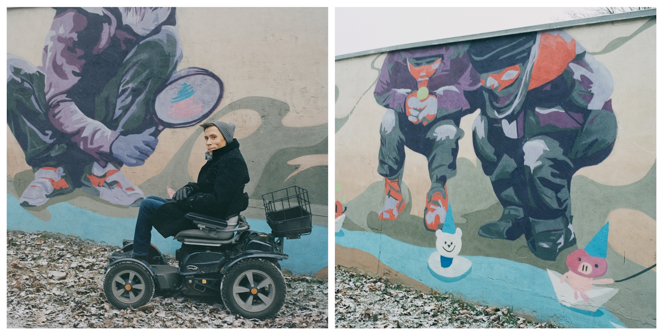 Photographic diptych made up of two square images. The image on the left shows a man using an off-road electric wheelchair. He is wearing jeans, a dark coat and a grey wooly hat and scarf. He is pictured sitting in his wheelchair from the side, looking to camera, arms crossed in his lap. Behind him is a large painted mural on a wall. The mural show a large child squatting down, holding a large magnifying glass. The juxtaposition makes it look like the painted child is looking at the man through the magnifying glass. The image on the right shows a different section of the same painted mural, this time from further away and without the man in the wheelchair. In this section two children are squatting down, looking at a couple of toy characters floating in a puddle of water.