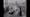 Image of women sitting down in two lines, facing each other. A nurse stands in the middle of them.